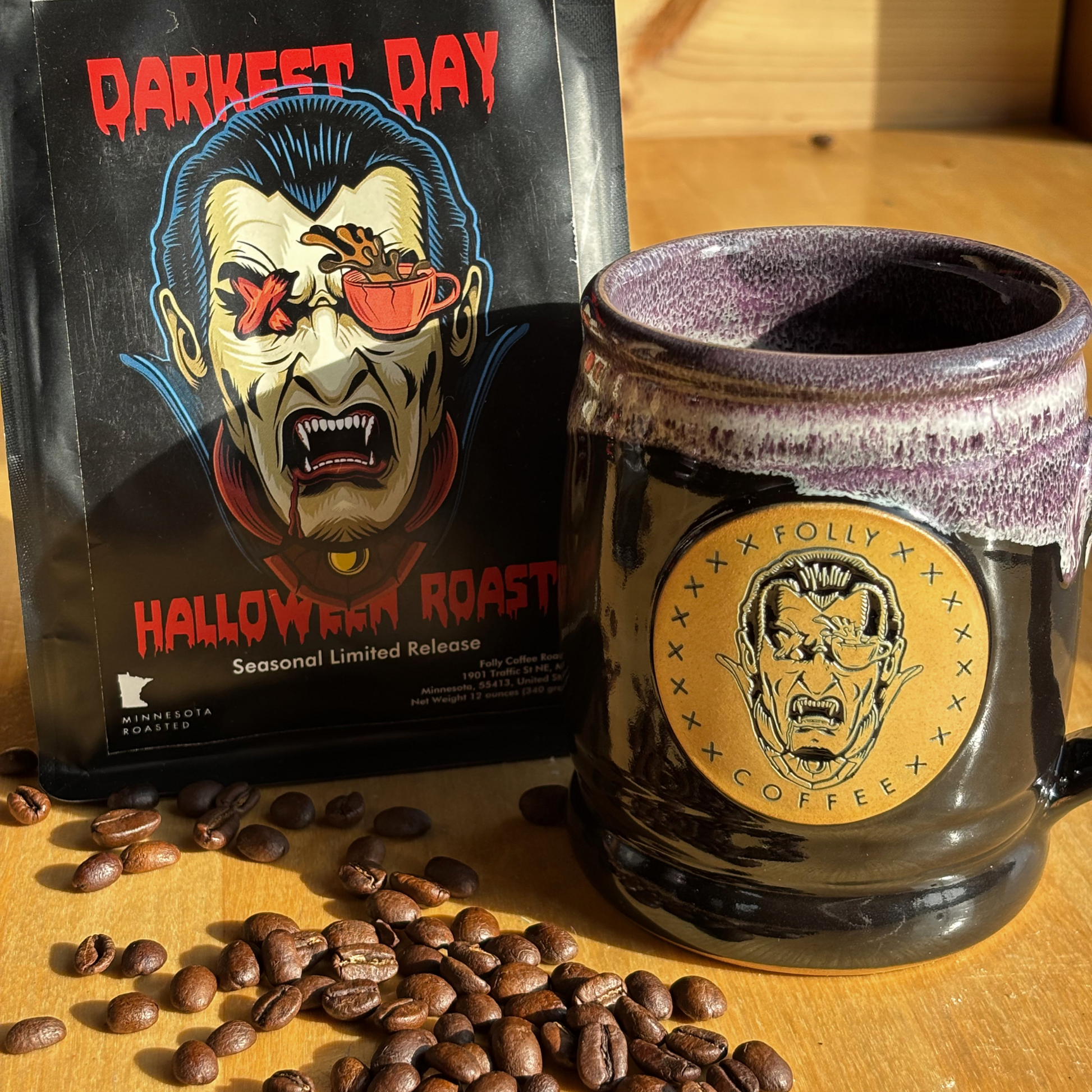 2024 Limited Edition Darkest Day stoneware mug with Folly Vampire emblem beside Darkest Day Halloween Roast coffee bag and beans